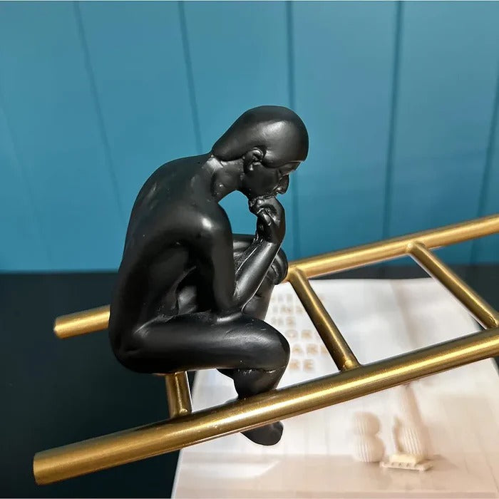 SEE SAW THINKING MAN SCULPTURE